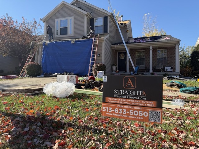 Job site set up: Tarps and a clean work area set up at the start of a roof replacement.