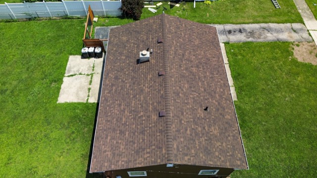 Long ranch roof: A full re-roof on a long, low ranch, finished with a straight ridge line.